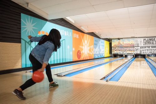 woman bowling on left end