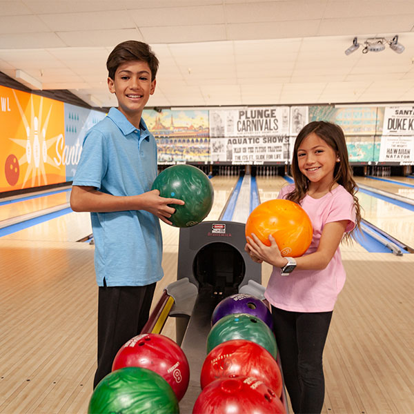 boy and girl bowling